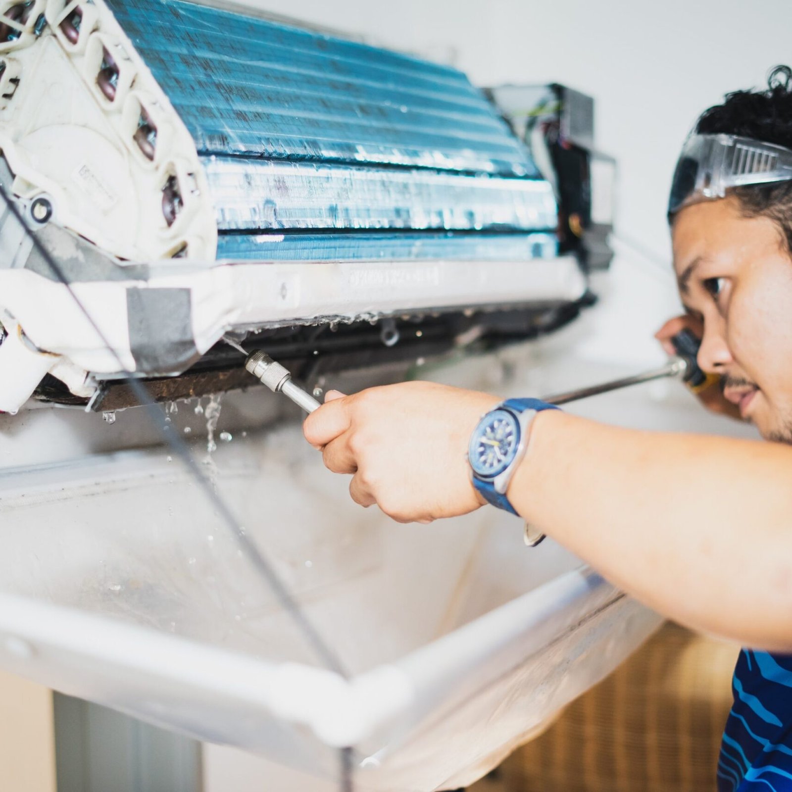 Spraying water while cleaning air conditioner indoors